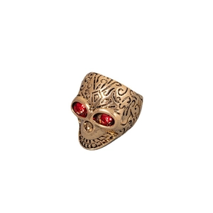 Vintage punk skull ring in antique gold finish with red crystal eyes on white background
