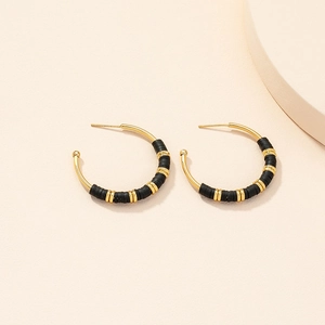 Chic gold hoop earrings with black heishi beads in a minimalist bohemian style