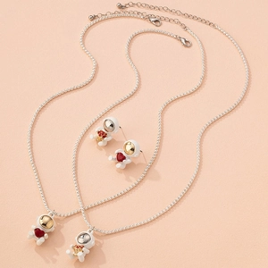 Astronaut jewelry set featuring heart and flower charms on silver bead chains
