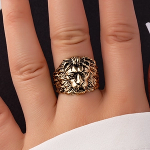 Close-up detail of vintage lion head ring in antique gold finish on finger