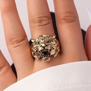 Macro detail of a vintage gold tiger head ring with realistic punk style carving