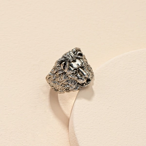 Detailed view of an antique silver lion head ring featuring intricate metal textures