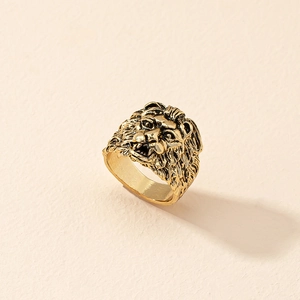 Macro detail of vintage golden lion head relief ring with intricate punk style engraving