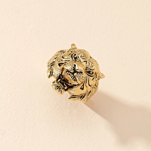 Detailed close-up of a vintage golden tiger head ring with intricate embossed textures