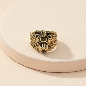 Macro close-up of a vintage golden lion head ring showing intricate carved mane details