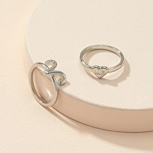 Silver zodiac heart ring set with ME engraving and wavy band on a minimalist stone base