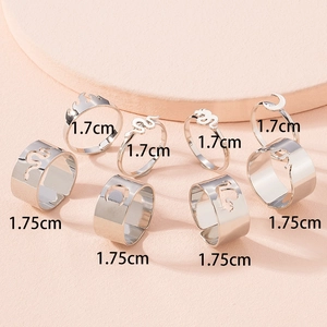 8-piece silver ring set featuring gothic snake flame and moon designs on pink stand