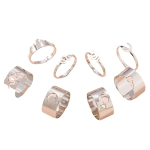 Set of 7 rose gold alloy rings with snake, moon, flame and cat motifs in minimalist style