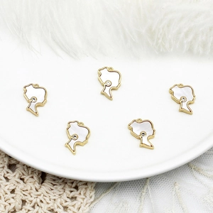 Macro detail of five 18K gold-plated portrait pendants with white shell inlay for DIY