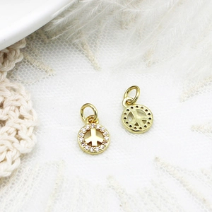 Close-up of gold peace sign charms with white zircon inlay for DIY jewelry design