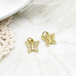 Macro detail of butterfly pendant with micro-pave zircons and honeycomb hollow back