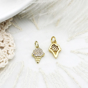 Macro view of gold ice cream cone jewelry charms with pave-set crystals and detail