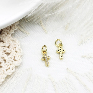 Macro detail of gold cross pendant with micro-pave zirconia for DIY jewelry making