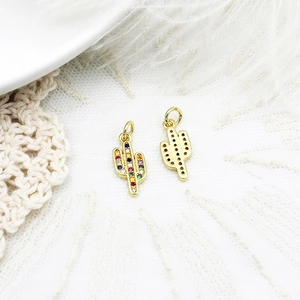 Macro detail of cactus charm with colorful pavé zircons and gold-plated finish