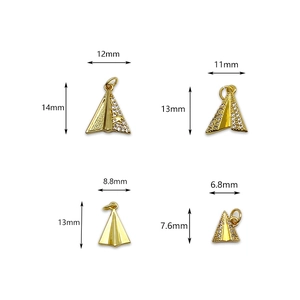 Golden paper plane charms with micro-paved zircons and star details in four sizes