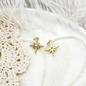 Macro view of 18K gold star pendant showing crystal pavé details and smooth back finish