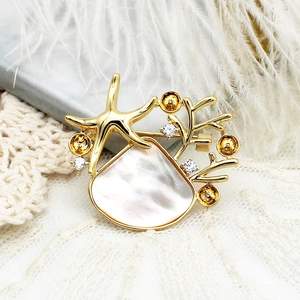 Elegant gold-plated starfish and coral brooch with iridescent shell and zircon accents