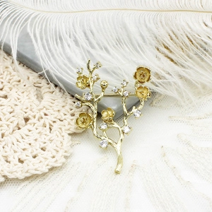 Elegant gold plated plum blossom branch brooch with white cubic zirconia accents