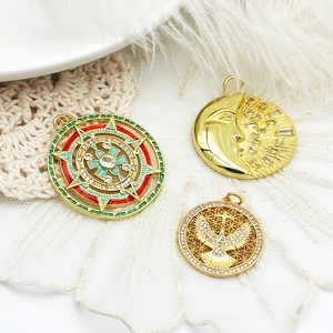 Golden moon and star pendants with micro-pave crystals on white lace background