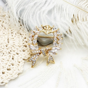 Elegant gold bow brooch with micro-pave crystals and sparkling wreath design for women