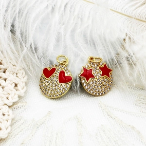 Macro shot of 18K gold plated micro-pave smiley charms with red heart and star details