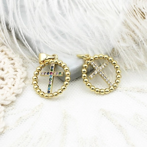 Close-up of 18K gold plated cross pendants with colorful and white cubic zirconia crystals