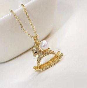Micro-pave carousel horse pendant necklace in 18K gold plating with pearl and zircon details