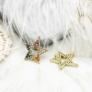 Macro detail of star charms with rainbow cubic zirconia and 18K gold plated connectors