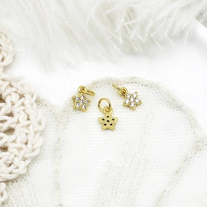 Macro view of 18K gold plated star pendants with micro-pave zircons and open back detail
