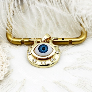 Detailed macro view of 18K gold plated evil eye pendant with blue enamel and zircons
