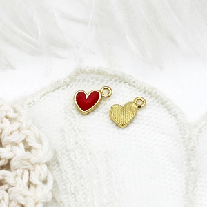 Detail of red enamel heart charms with 18K gold plating for DIY jewelry making