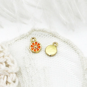 Detail view of 18K gold plated orange slice pendants for DIY jewelry crafting