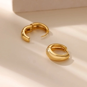 Minimalist chunky golden hoop earrings with high polish finish and snap closure