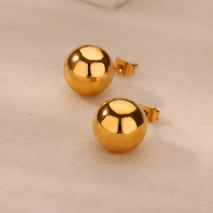 Macro shot of 18k gold plated geometric ball stud earrings with butterfly backs