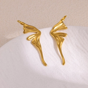 Minimalist stainless steel golden butterfly earrings with liquid metal texture on white ceramic
