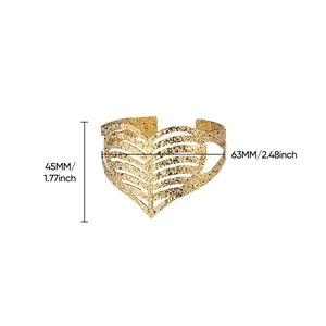 Detailed view of hammered gold wide cuff bracelet with heart cutout and dimensions