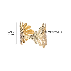 Detailed view of wide 18K gold-plated cuff with leaf patterns and hammered texture