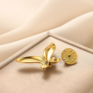 Elegante spilla a farfalla in oro con zirconi e perle su tessuto di seta avorio