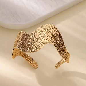 Minimalist wide open gold bracelet with hammered texture and wavy design for women