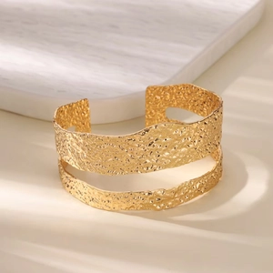Minimalist wide open cuff bracelet in 18K gold finish with hammered texture design