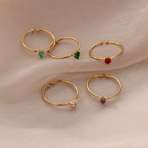 Set of five adjustable gold rings with colorful heart shaped zircon stones on silk