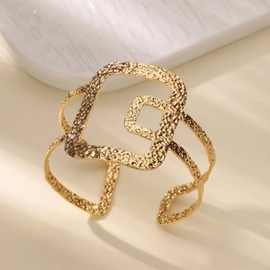 Minimalist wide open cuff bracelet in 18K gold finish with hammered geometric texture