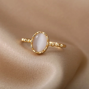 Detailed macro shot of oval cat-eye stone on beaded gold plated stainless steel ring