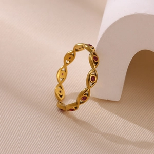 Gros plan d'une bague œil protecteur plaquée or avec des accents de zircon rouge
