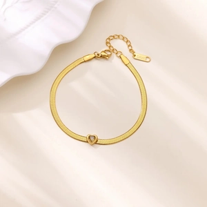 Detailed macro view of the gold snake chain with heart pendant and lobster clasp