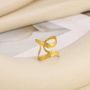 Detail of gold-plated geometric ring with hammered texture on a neutral display