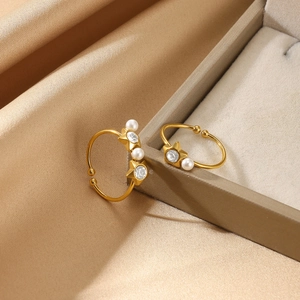 Elegant gold-plated star rings with pearls and zircon on premium silk background