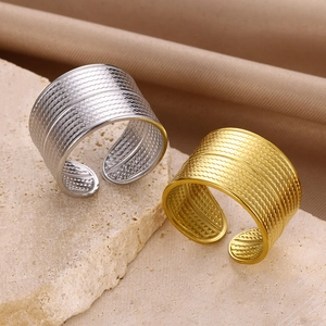 Wide band stainless steel clover rings in gold and silver with vintage scale textures