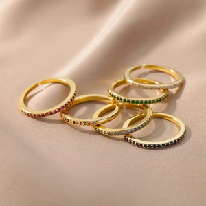 Elegant gold adjustable rings set with multi-colored cubic zirconia on champagne silk