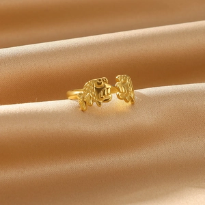 Detailed close-up of golden koi carp fish ring with pearl on champagne silk background